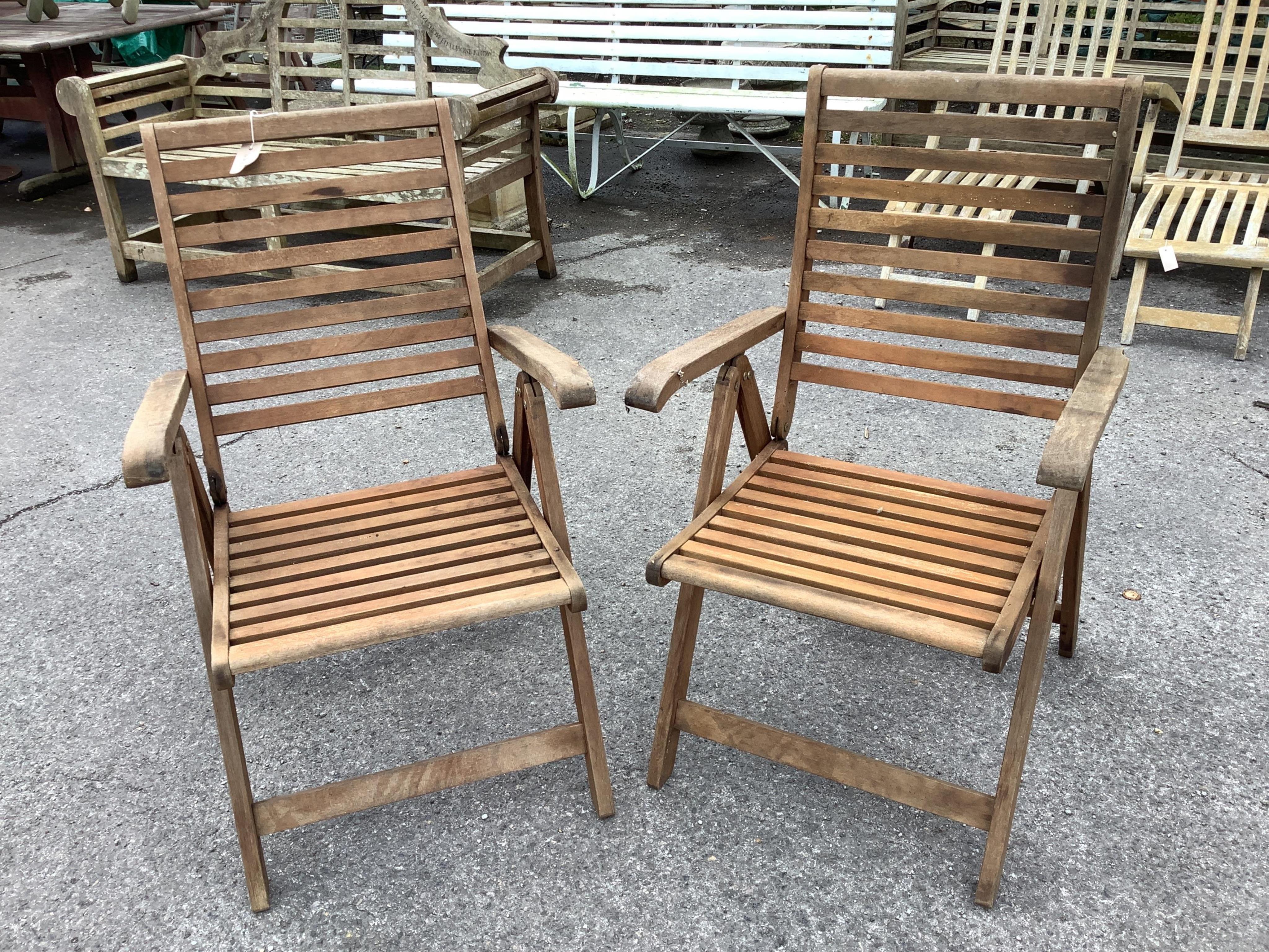 A Westminster rectangular weathered teak extending garden table, width 140cm, depth 90cm, height 73cm, (leaves inoperable), together with a pair of teak folding garden chairs. Condition - fair